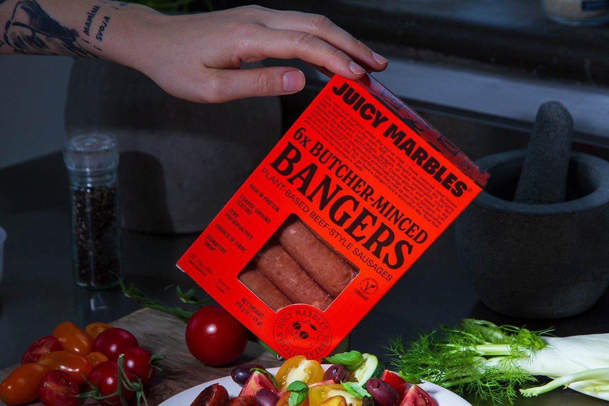 Juicy Marbles launches butcher-style vegan bangers with visible fat marbling in UK